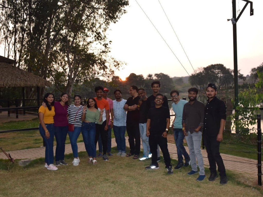 Team outing at sunset by the water