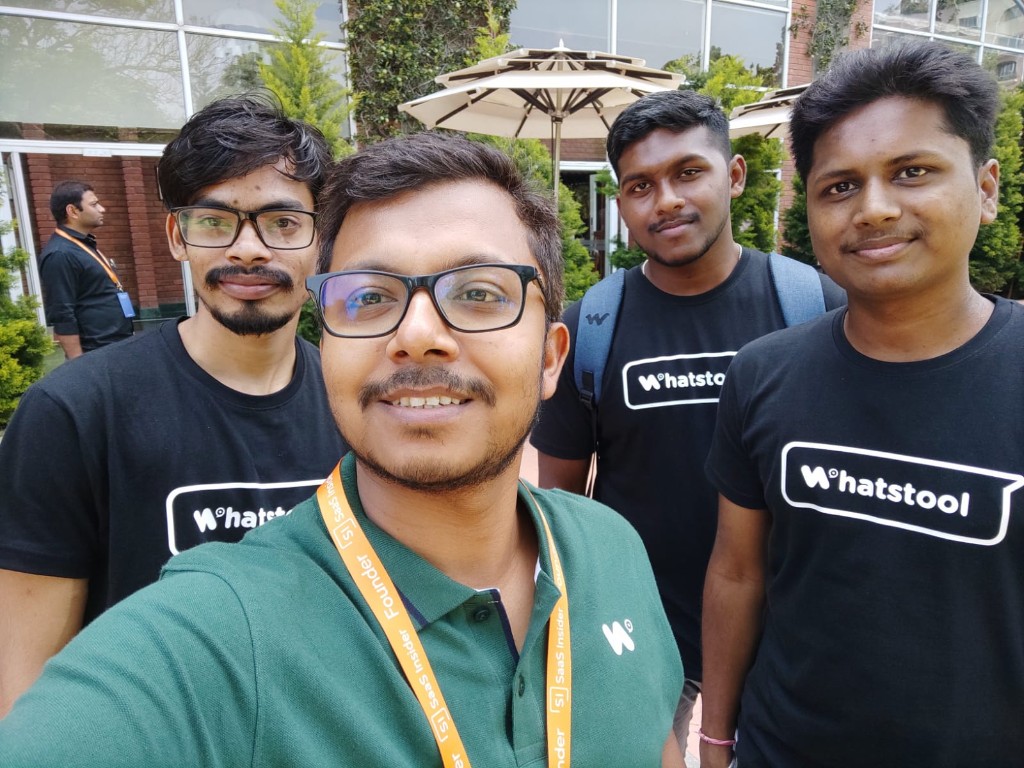 Team selfie at an outdoor event wearing WhatsTool shirts
